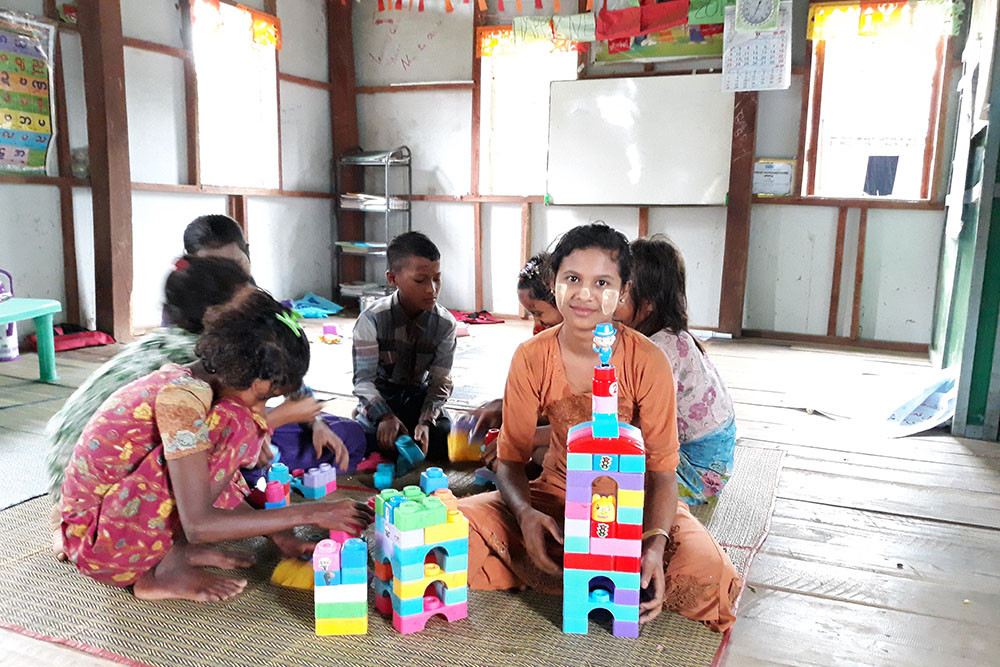 Children play with building blocks at one of Plan's child friendly spaces in Myanmar