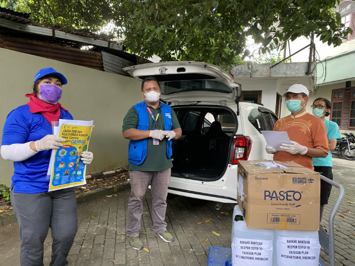 Plan International staff distributing hand sanitiser and soap in South Jakarta