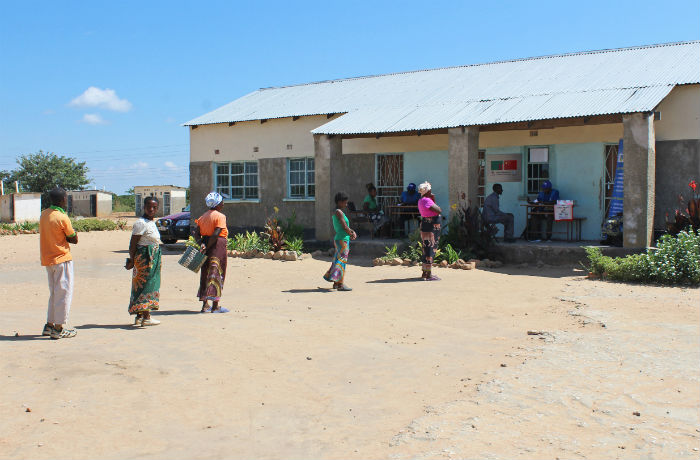Parents observe social distancing during food distribution in Zambia