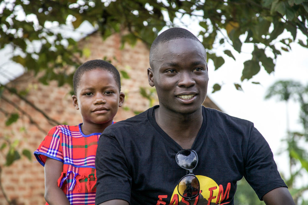 Allan with his niece, standing up for gender equality in Uganda
