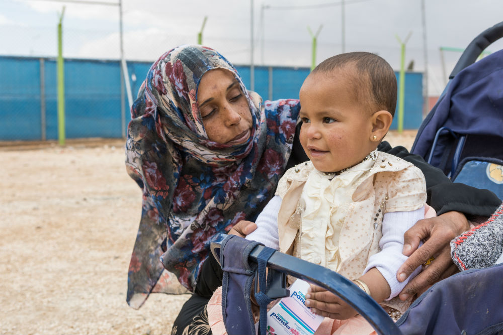 Layla with her youngest child at refugee camp in Jordan