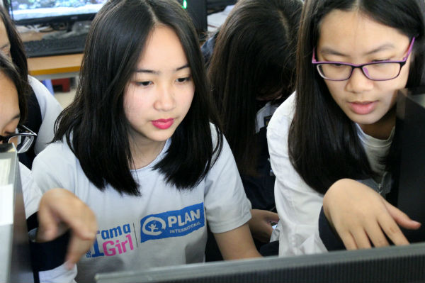 Group of girls planning their dream city at Minecraft workshop in Vietnam