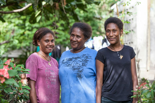 Monica, Wendy and Neslyn outside their home in Honiara