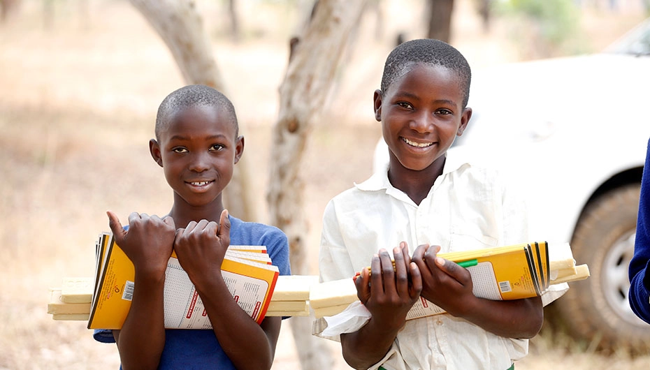 Girls with soap, exercise books and pencils from Plan International