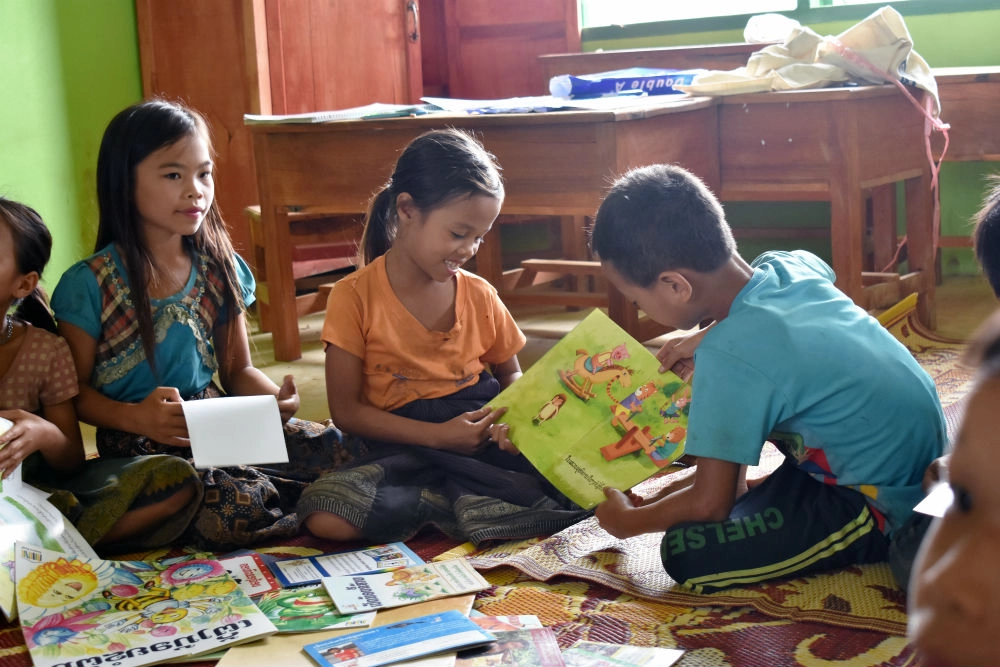 Lamboud, 9, and Duam, 11, read books together at the children's literacy club 