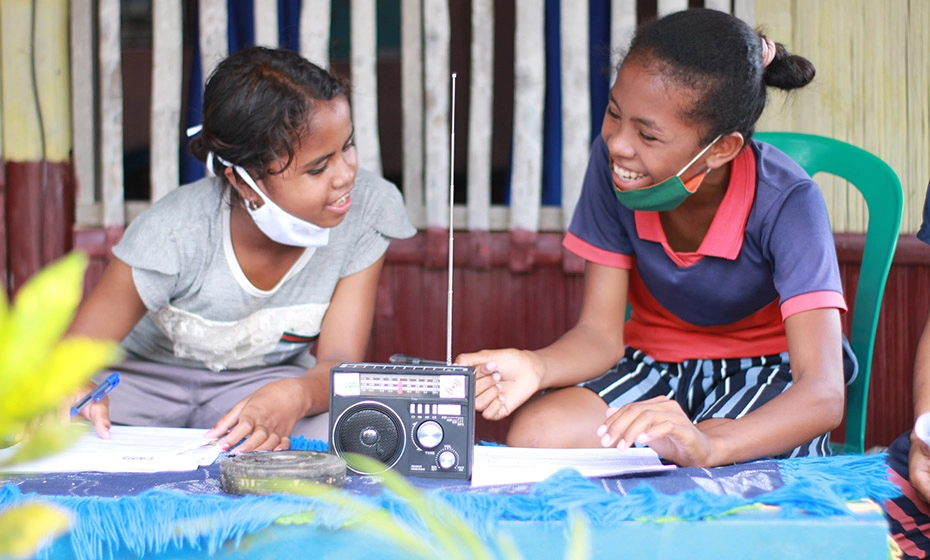 Maria & Maria in Indonesia studying with their new radio provided by Plan International