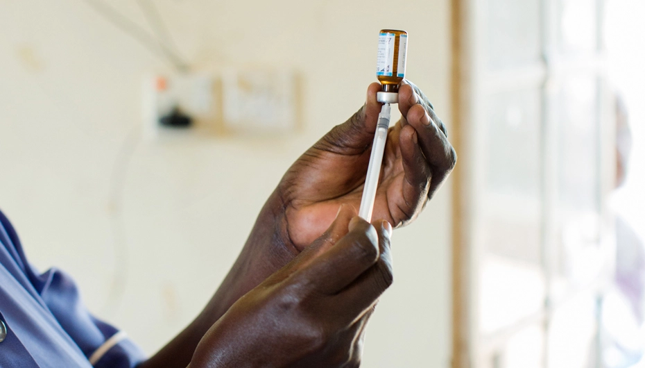Nurse prepares immunisation at Village Health Centre, Uganda