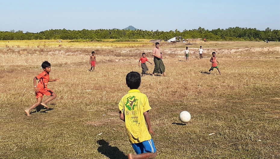 Children play football at one of the child friendly spaces in Rakhine state