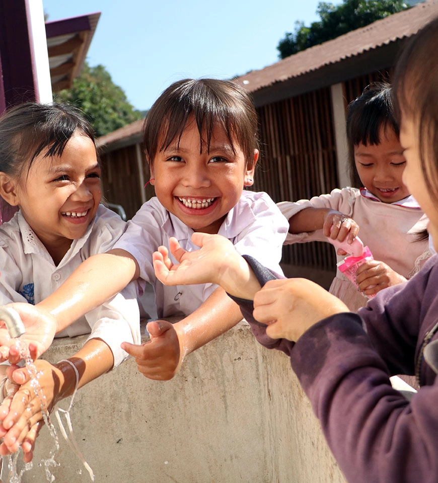 Souda and her friends wash their hands using the new handwashing facilities