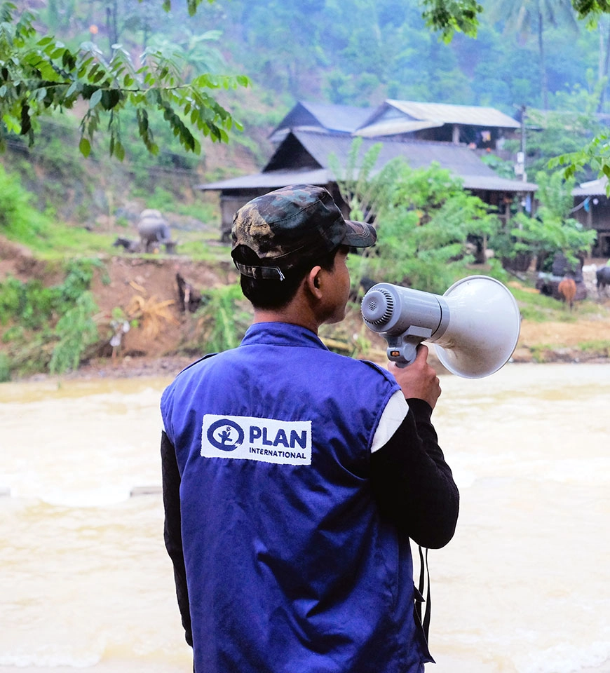 Ho Van Nheng using the loudspeaker to warn villagers about the potential flood risks