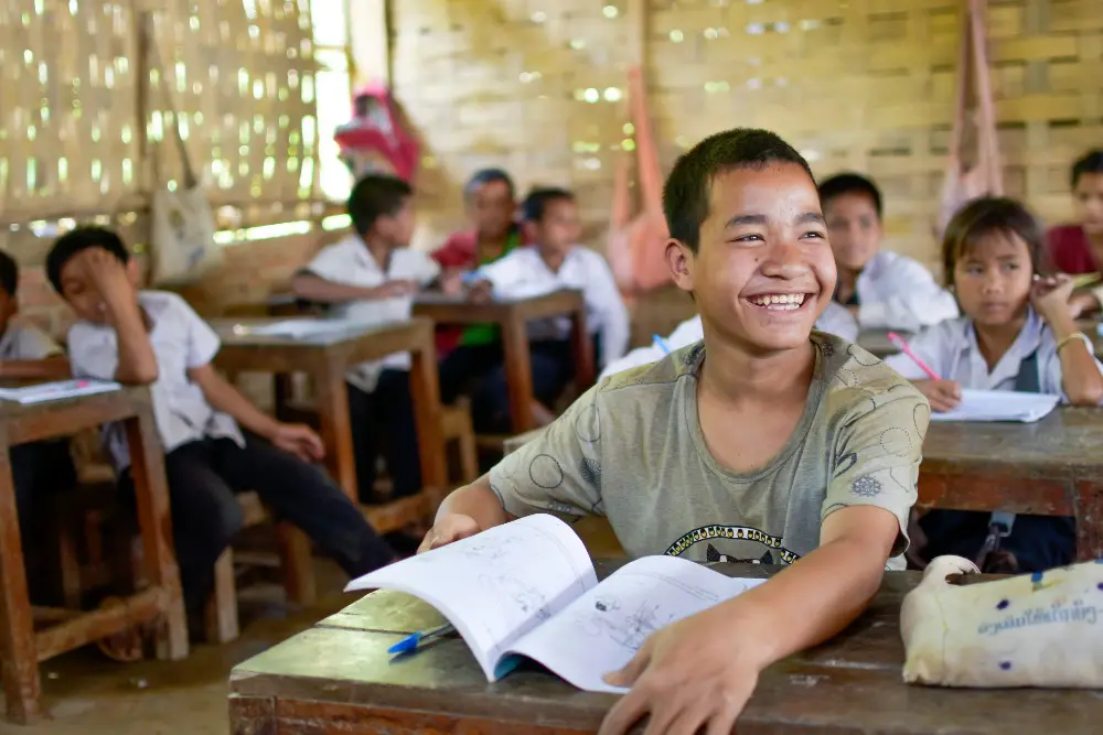 Nak enjoys learning in class at his school in northern Laos 