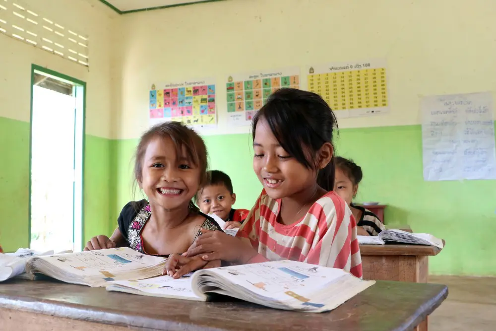 Da, 6, and her friend enjoy their Lao lesson at school.
