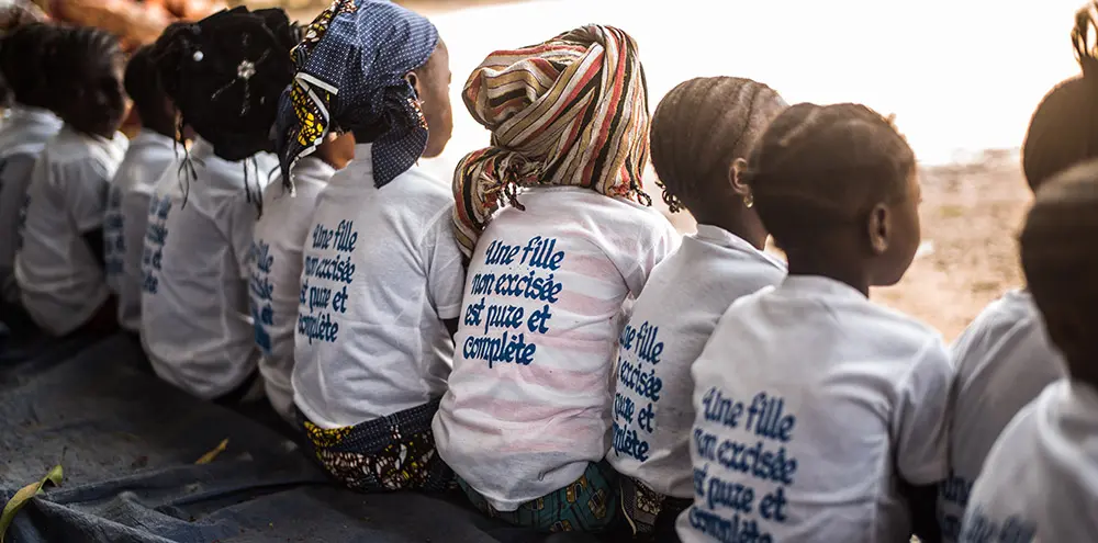 Village in Guinea celebrates the abandonment of Female Genital Mutilation (FGM) with girls wearing t-shirts with the message 'An uncut girl is pure and complete’