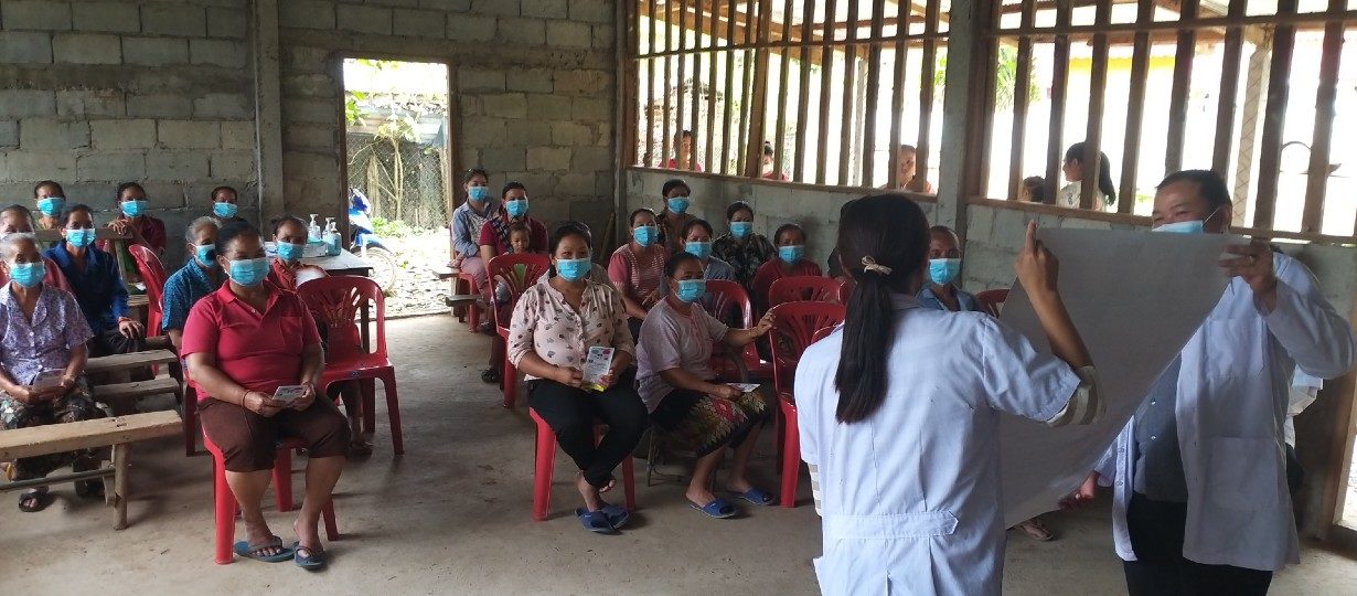 Health Centre staff and village health volunteersraise awareness about COVID-19 at a community level in Oudomxay Province