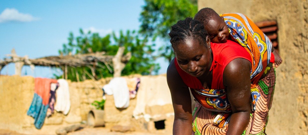 Awa, 30, washes dishes at her home in Mouhoun region