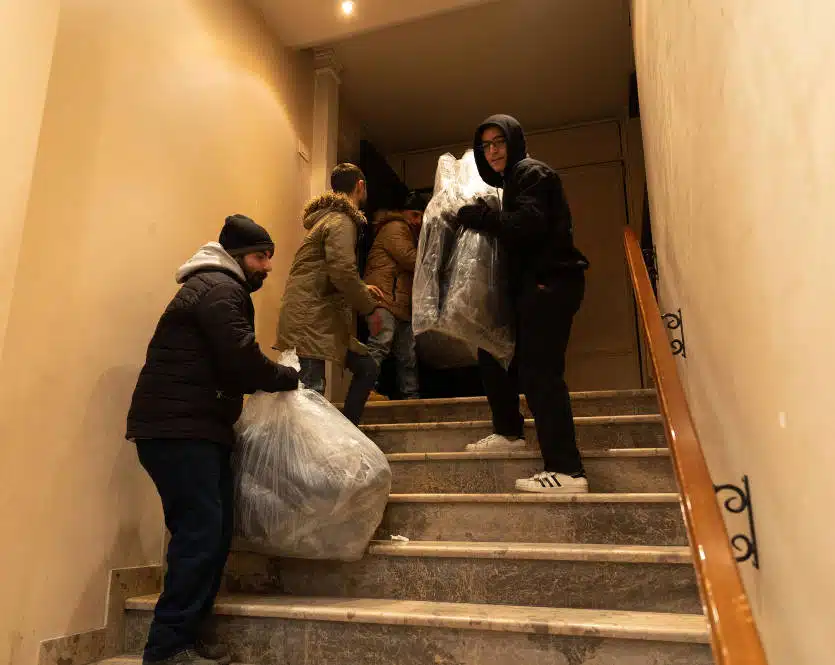 Unloading blankets for people sheltering in church in Aleppo 7 Feb 2023
