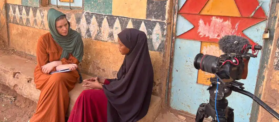 Photo: Stephanie March and Hinda conduct an interview in her village of Haroshiekh