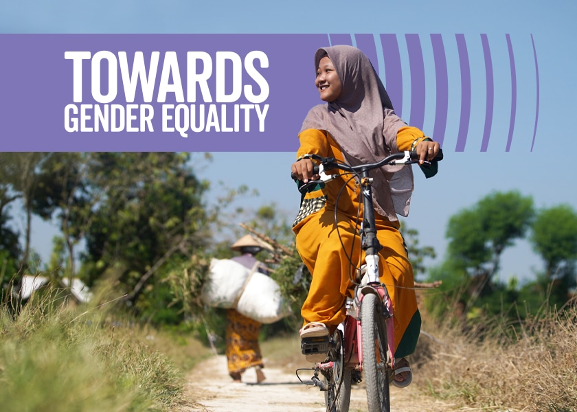 A woman riding a bicycle with the heading: Towards gender equality