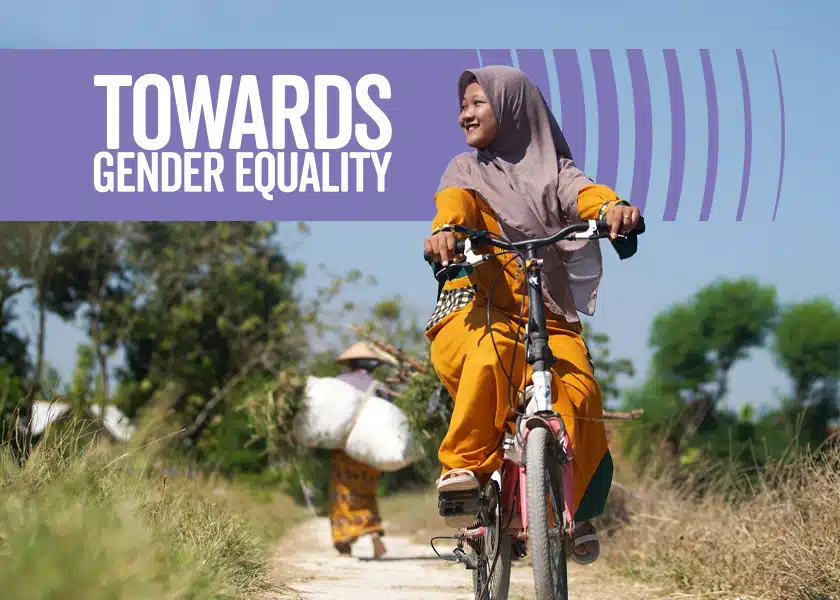 A woman riding a bicycle with the heading: Towards gender equality