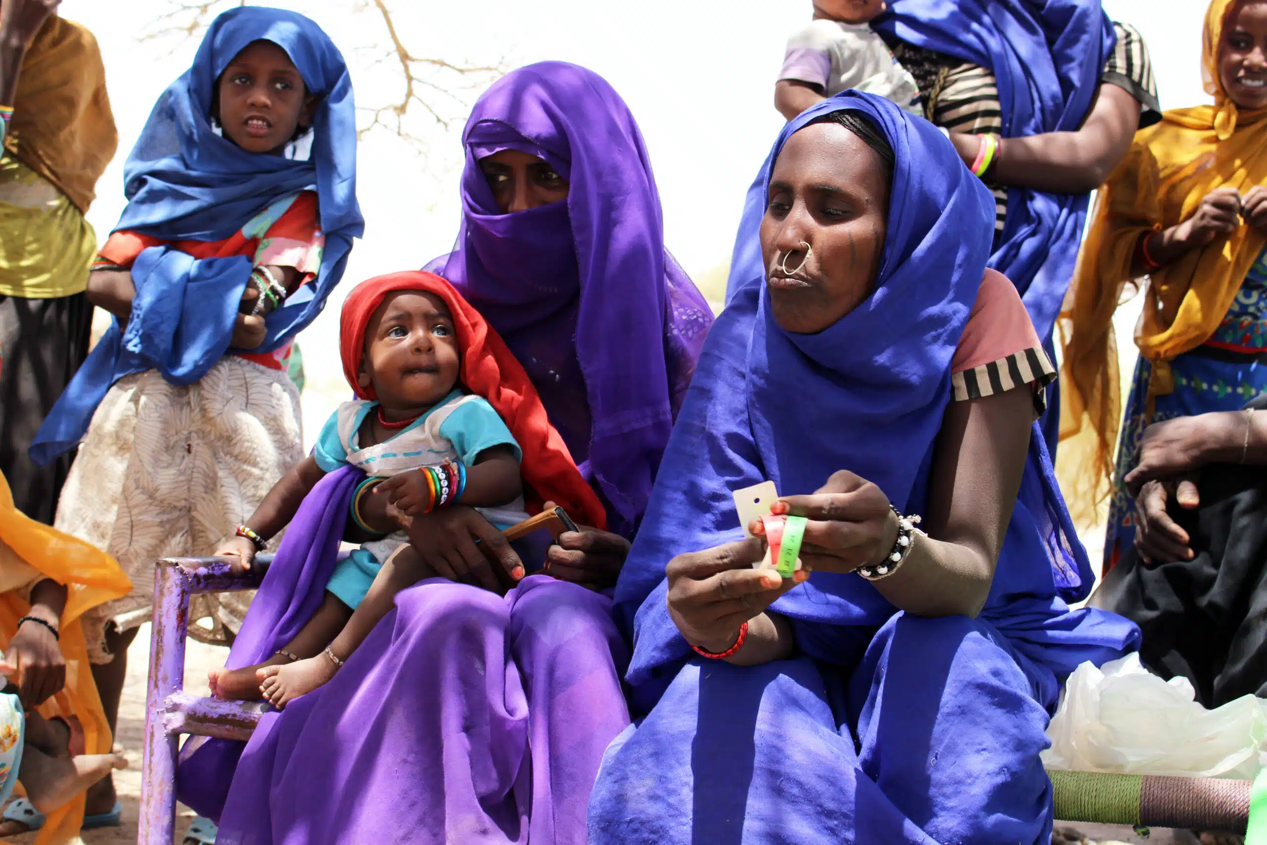 Mothers take their underweight children to mobile nutrition session