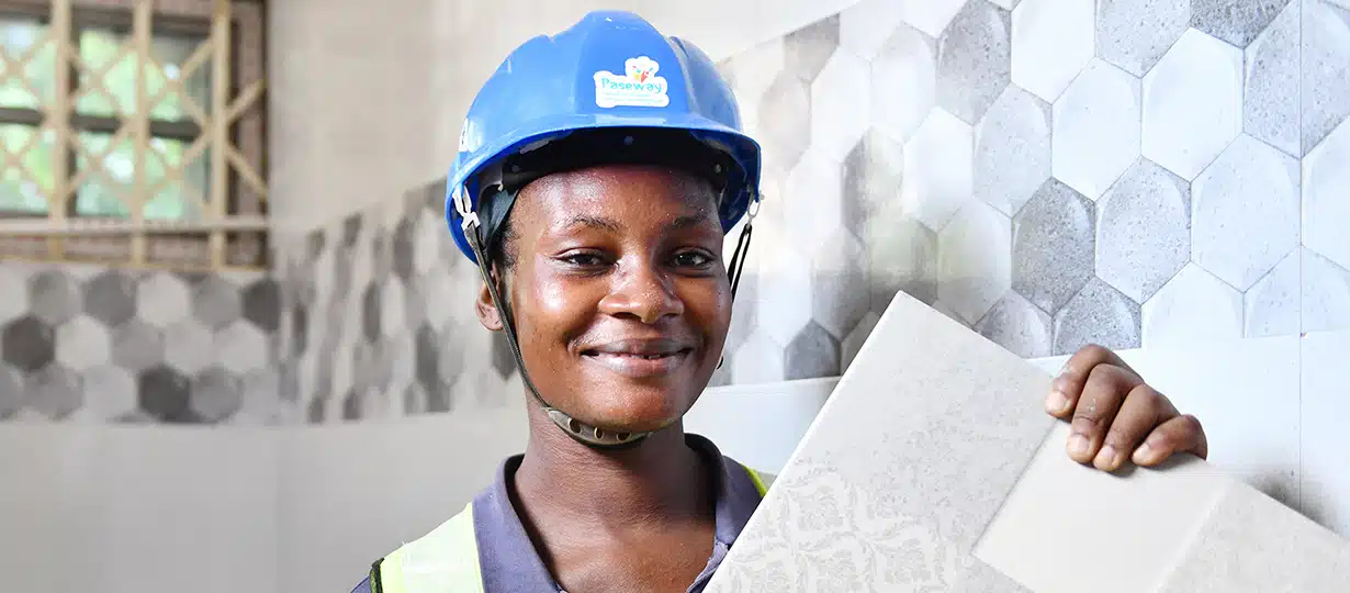 Ayisha, 27, is one of six females in a crew of ten tile layers in Tamale, Northern Ghana. 
Photo by Plan International