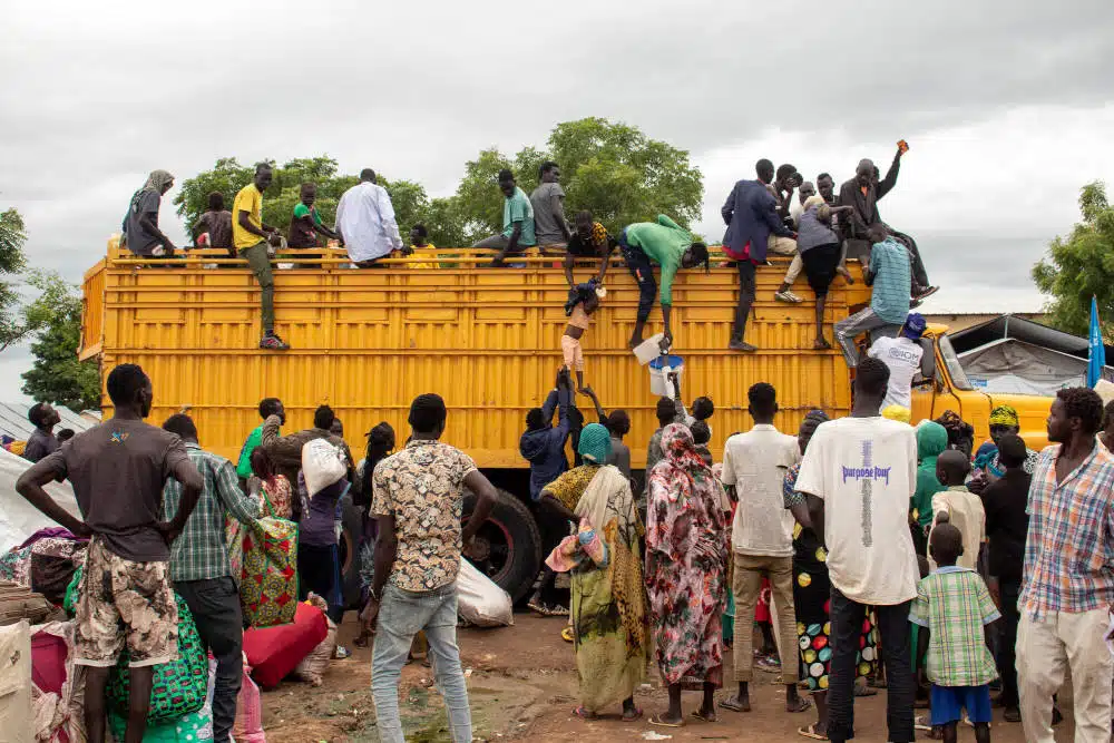 Refugees around an aid truck in a transit centre, South Sudan