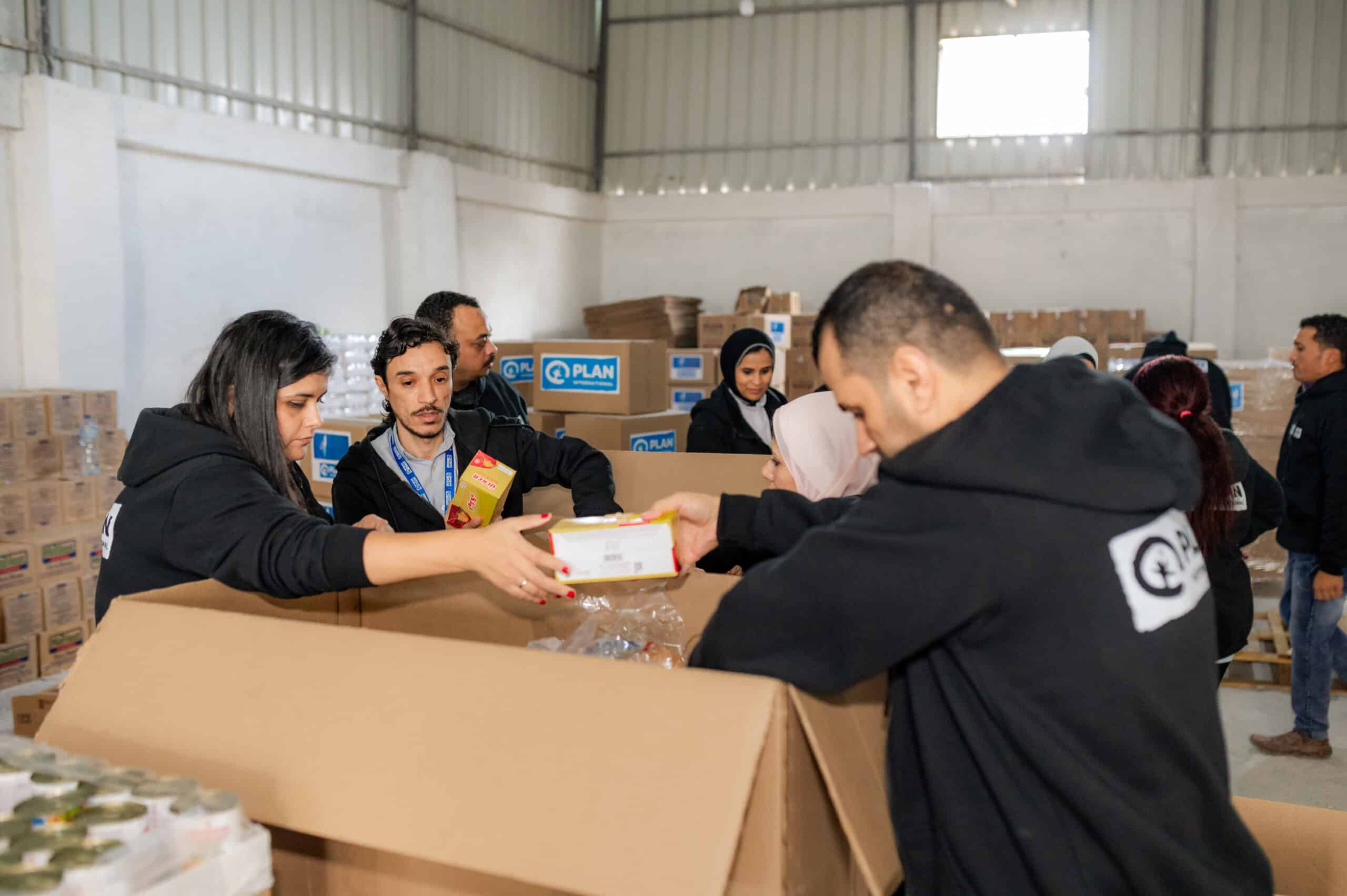 Plan International staff in Egypt readying boxes of food to be transported across the border into Gaza.