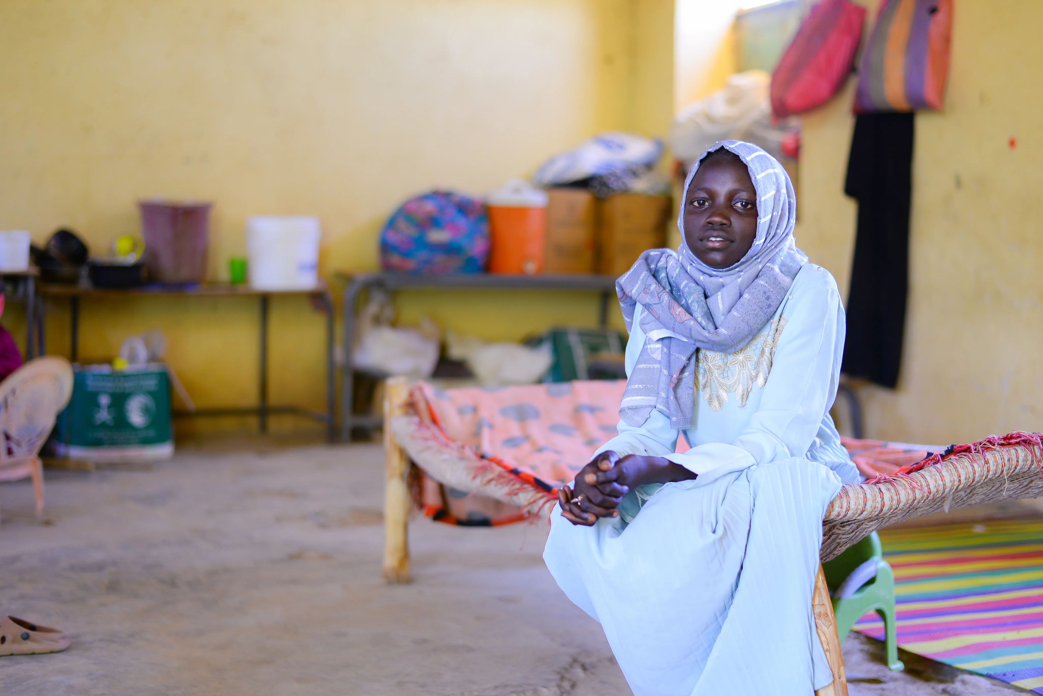 Muna, 13, is now living in a school in eastern Sudan
