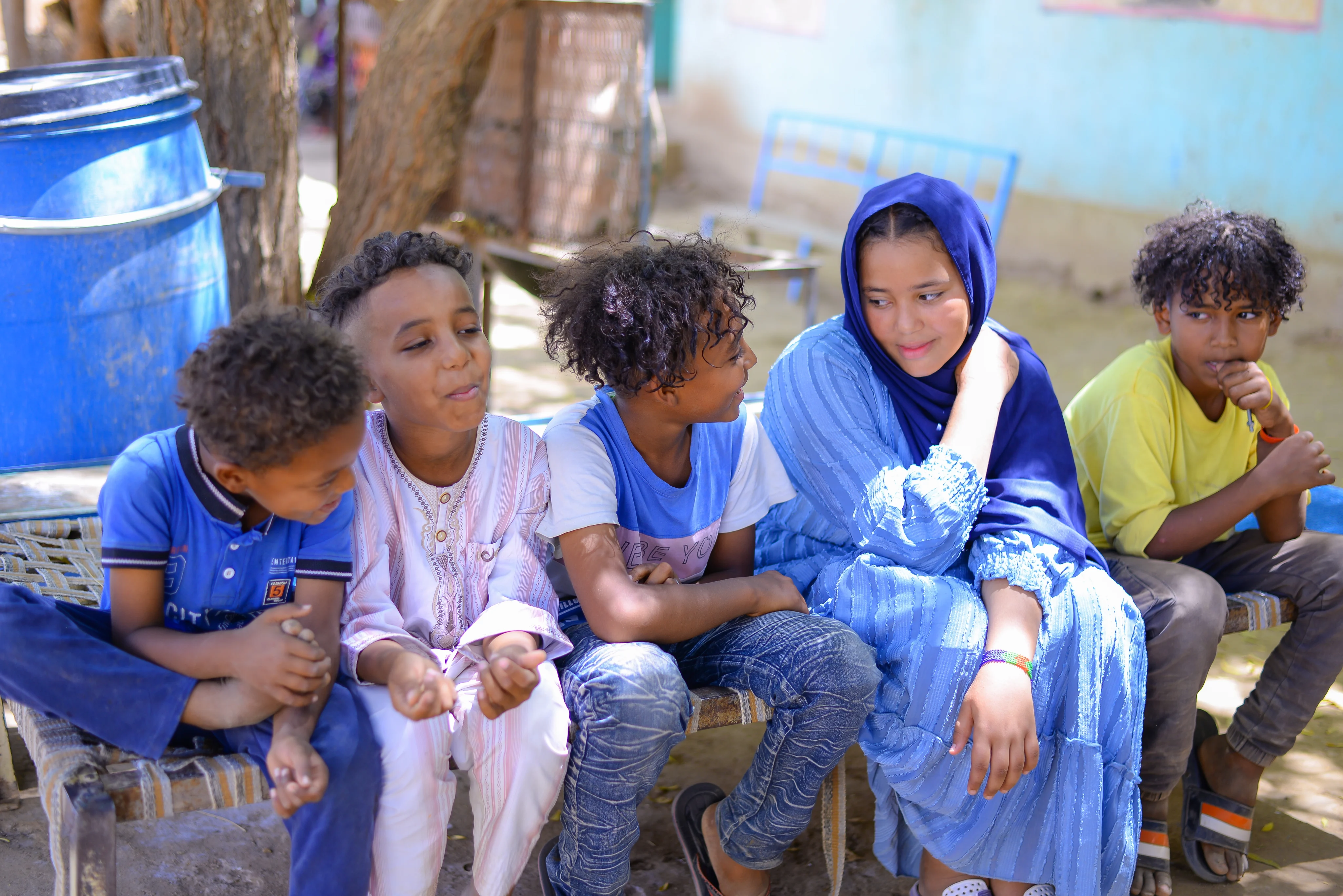 Angham, 14, with her younger brothers