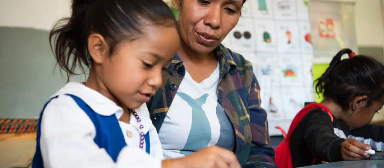 A mother in remote Timor Leste helps in her daughter's classroom.
