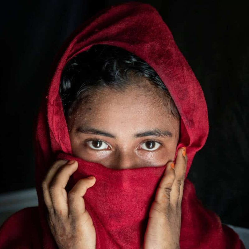 Photo of a girl with a scarf covering her face