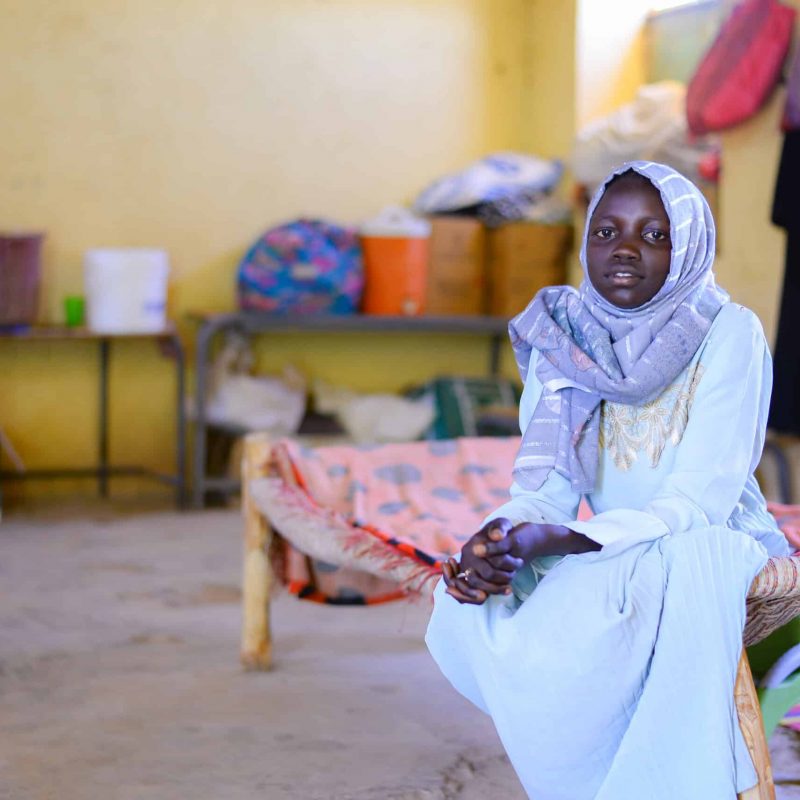 Muna, 13, is now living in a school in eastern Sudan