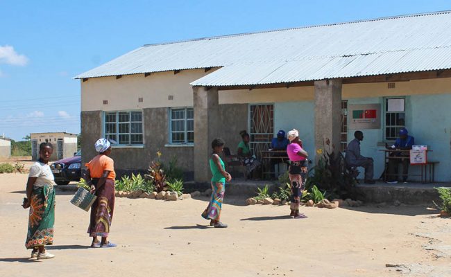 Parents observe social distancing during food distribution in Zambia